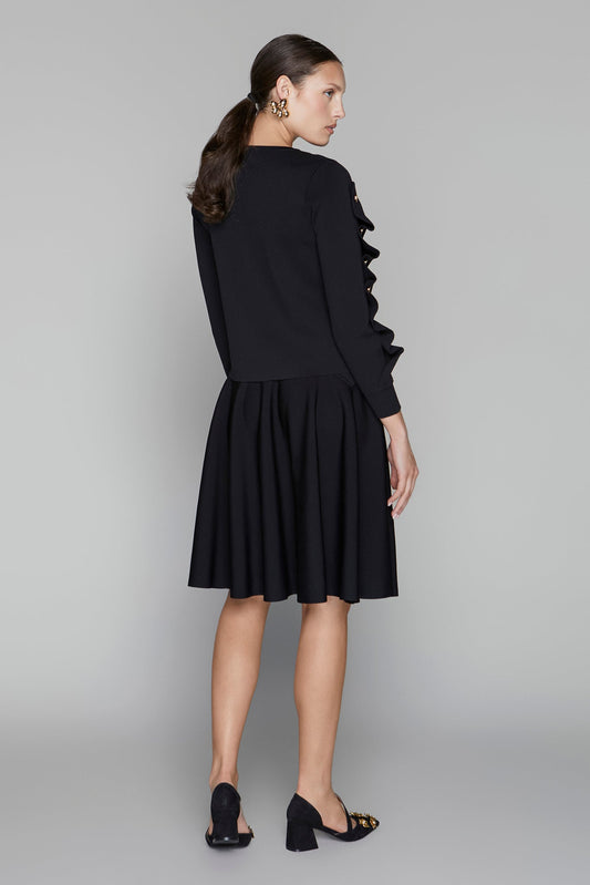 Woman wearing a black dress with a gray background