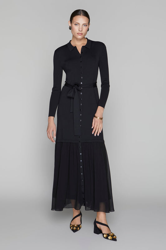 Woman wearing a black dress with a belt on a gray background