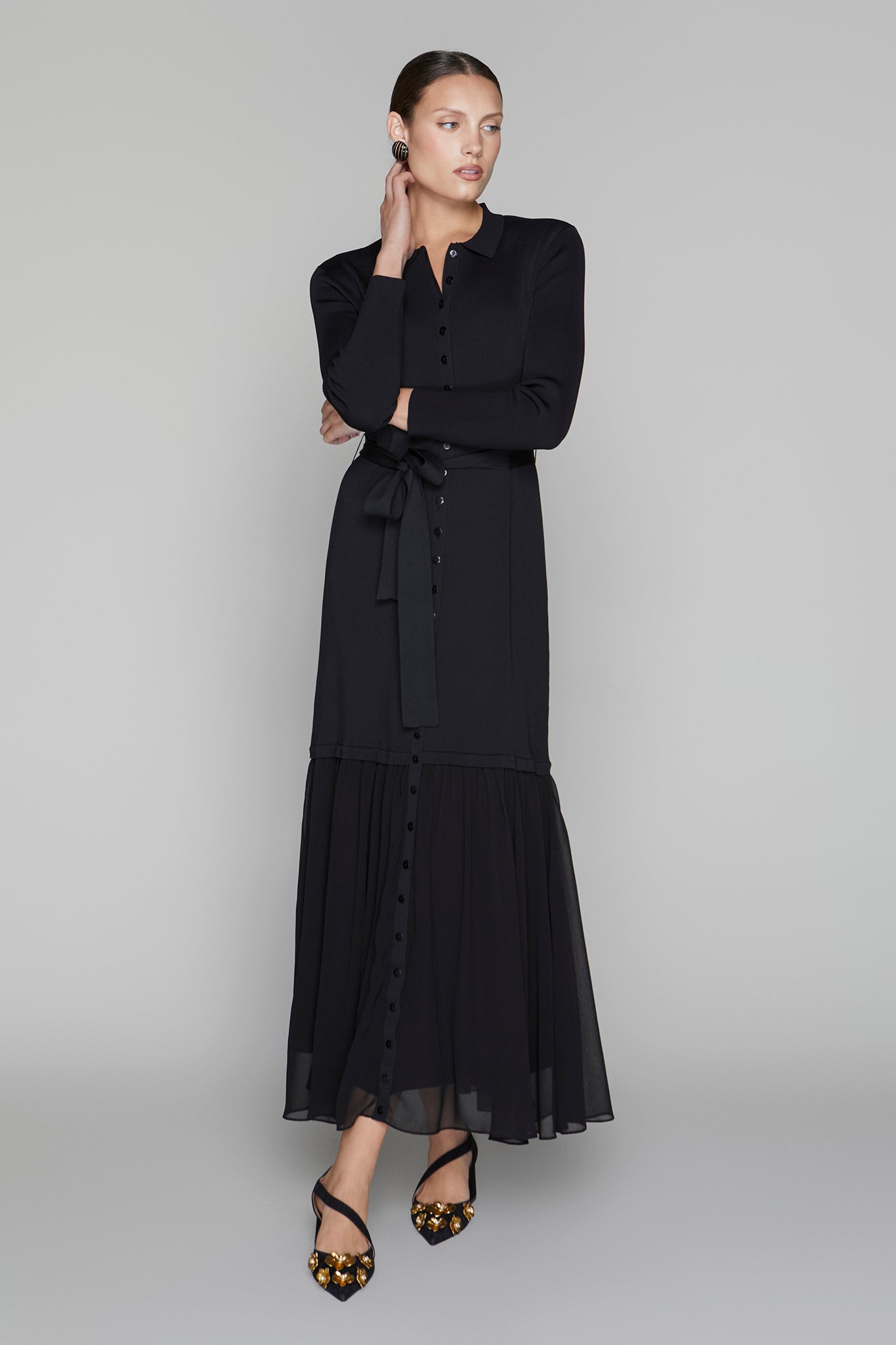 Woman wearing a black dress on a gray background