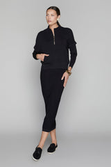 Woman wearing a black outfit on a gray background