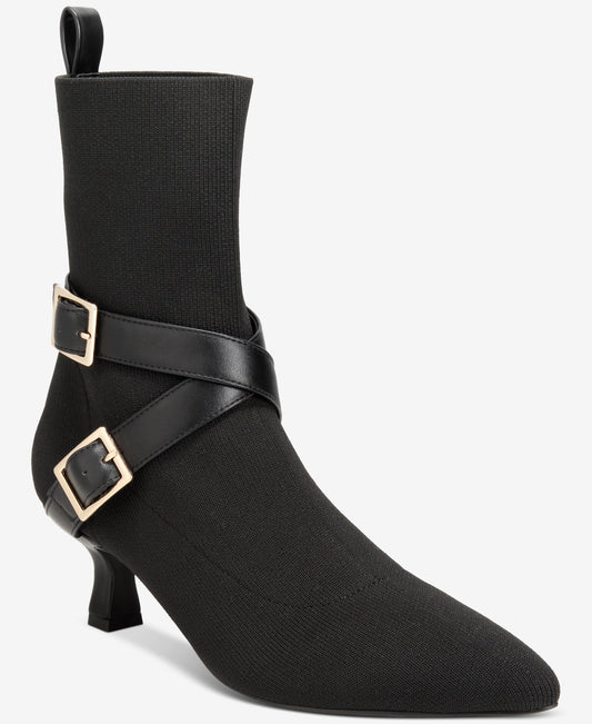 Black ankle boot with gold buckles on a white background