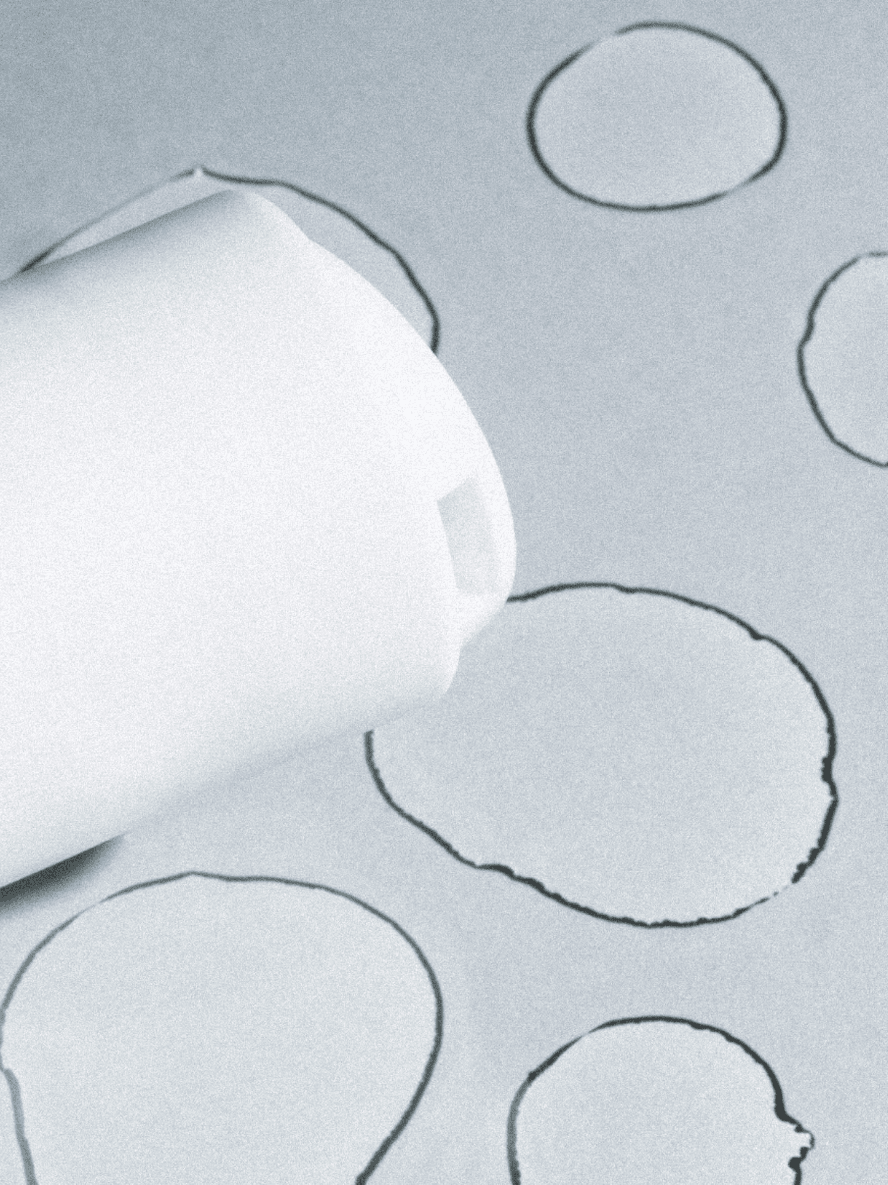Roll of white paper with circular cutouts on a gray background