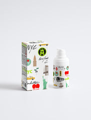 Bottle and packaging with New York City-themed design on a white background