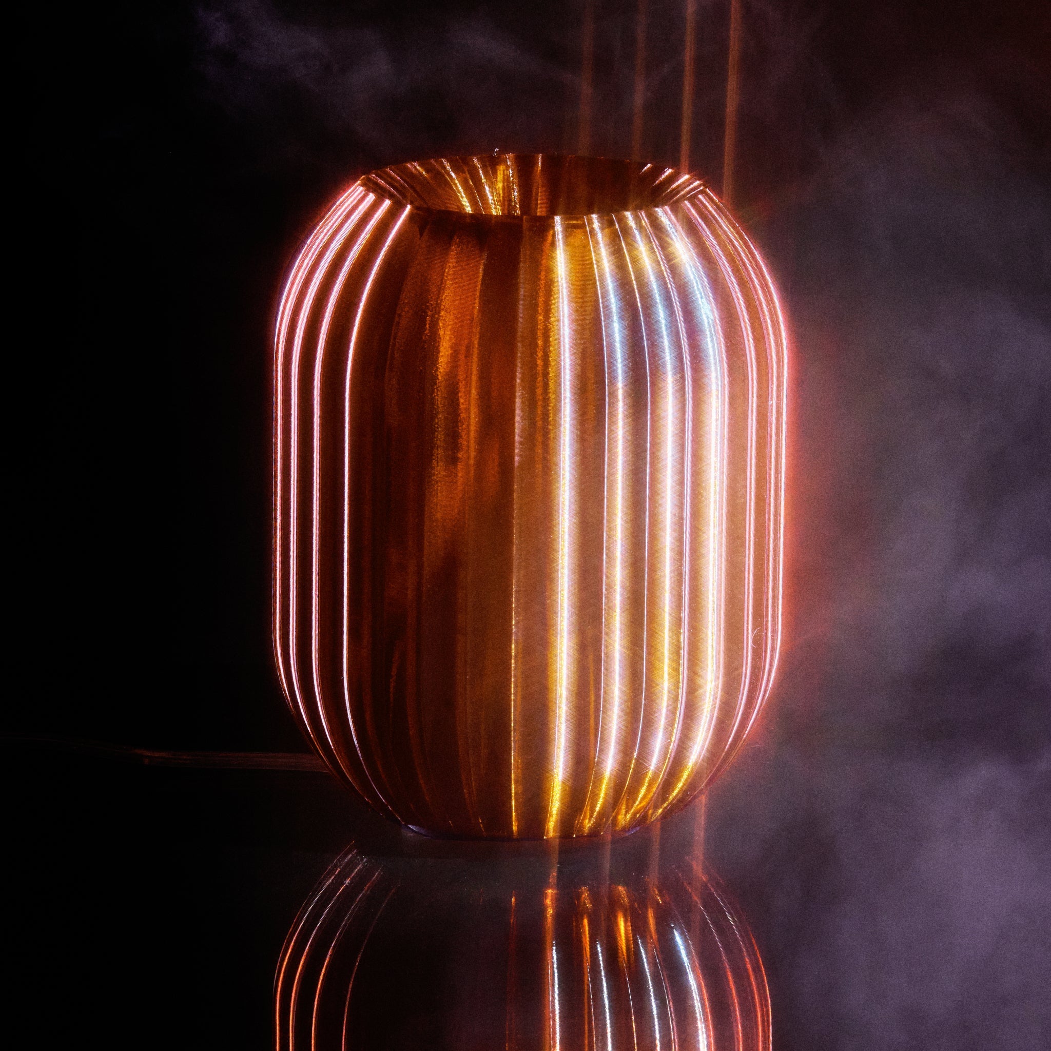 Decorative lamp with ribbed design on a dark background