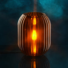 Decorative lamp with ribbed design on a reflective surface against a dark background