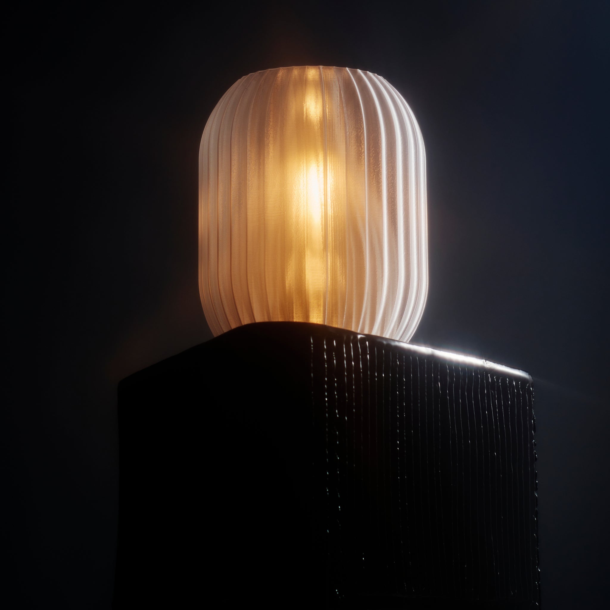 Decorative lamp with ribbed design on a dark background