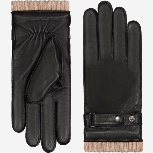 Black leather gloves with beige lining on a white background