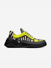 Sneaker with black, yellow, and zebra pattern on a white background