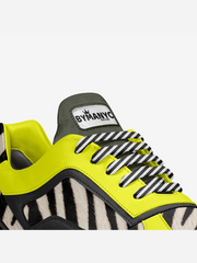 Sneaker with zebra pattern and yellow accents on a white background