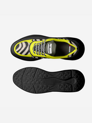 Black and yellow athletic shoe with sole view on a white background