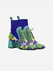 Colorful floral-patterned boots with green laces on a white background
