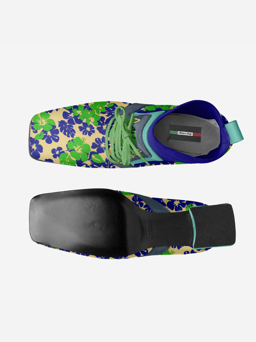 Colorful shoe with floral pattern and black sole on a white background
