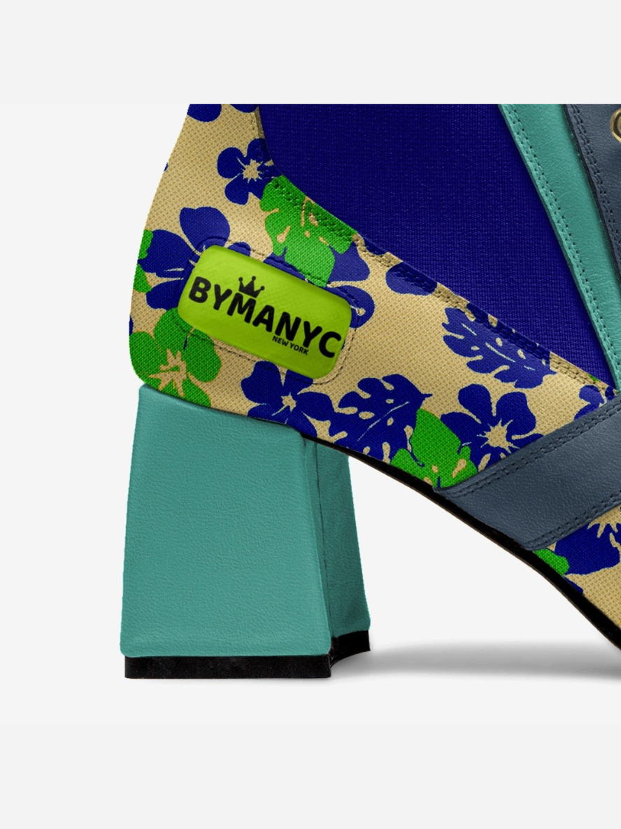 Close-up of a bag with floral pattern and 'BYMANYC' label on a white background