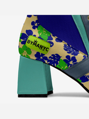 Close-up of a bag with floral pattern and 'BYMANYC' label on a white background