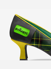 High-heeled shoe with green and yellow accents and a visible brand logo on a white background