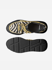 Black and gold sneaker with zebra pattern on a white background