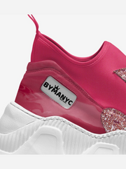 Pink sneaker with white sole and 'BY MANYC' label on a light gray background