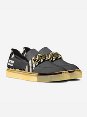 Black and gold sneaker with zebra pattern on a white background