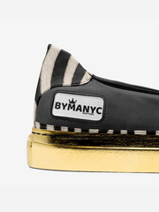 Black shoe with zebra pattern heel and gold sole, featuring BYMANYC branding.