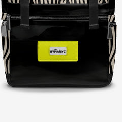 Black backpack with zebra pattern straps and a yellow label on a white background
