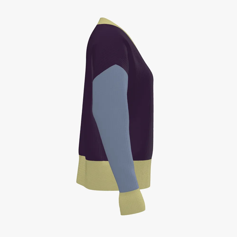 Color-blocked sweater with purple, blue, and beige sections on a white background