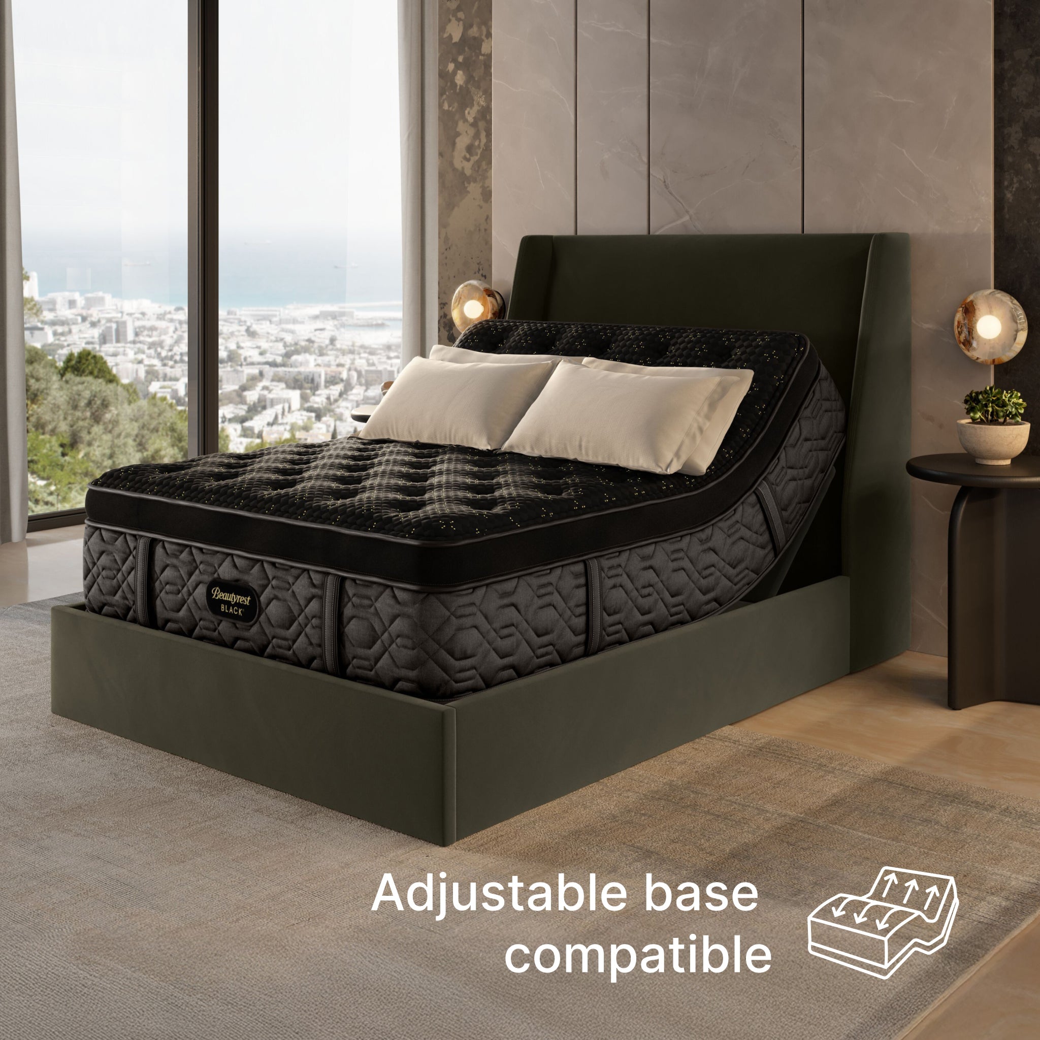 Black adjustable base bed in a modern room with large windows.