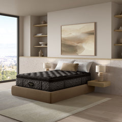 Mattress on a bed in a modern bedroom with shelves and artwork.