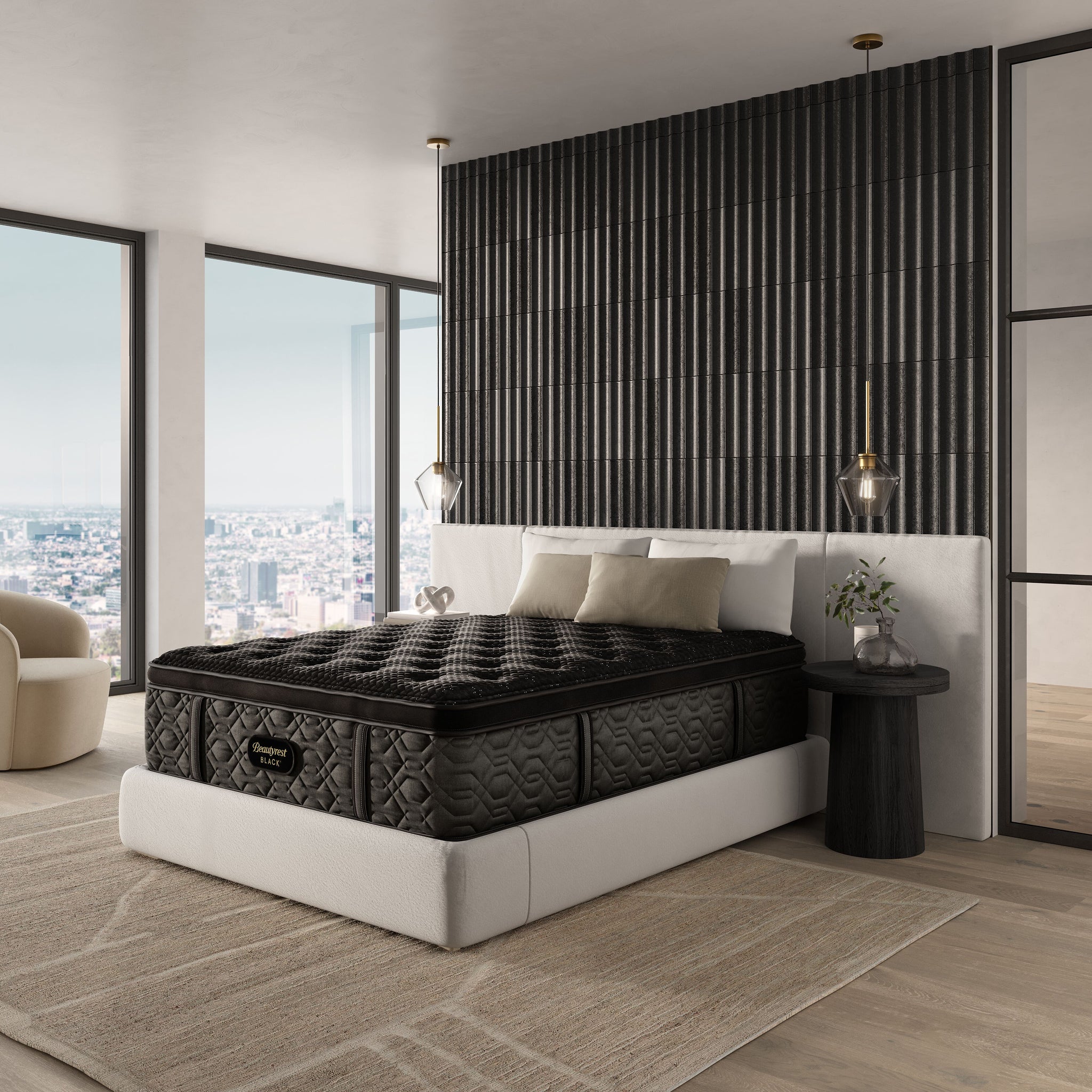 Black mattress on a white bed frame in a modern bedroom with large windows and decorative elements.