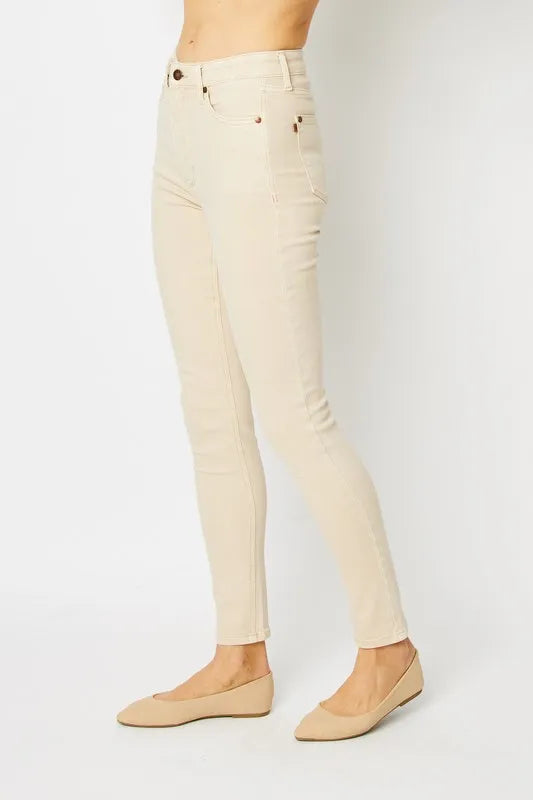 Beige pants worn by a person on a white background