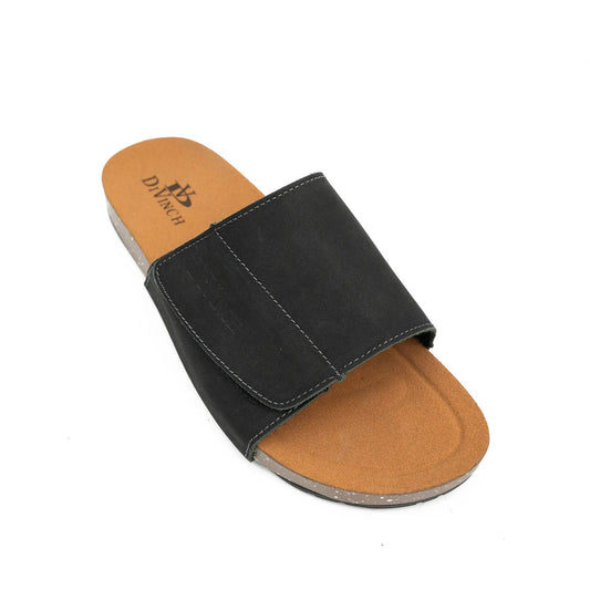 Black sandal with tan sole on a white background