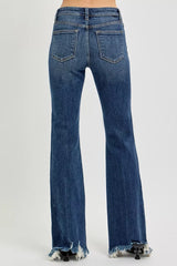 Blue jeans with frayed hem on a white background