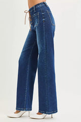 Blue jeans worn by a person on a white background