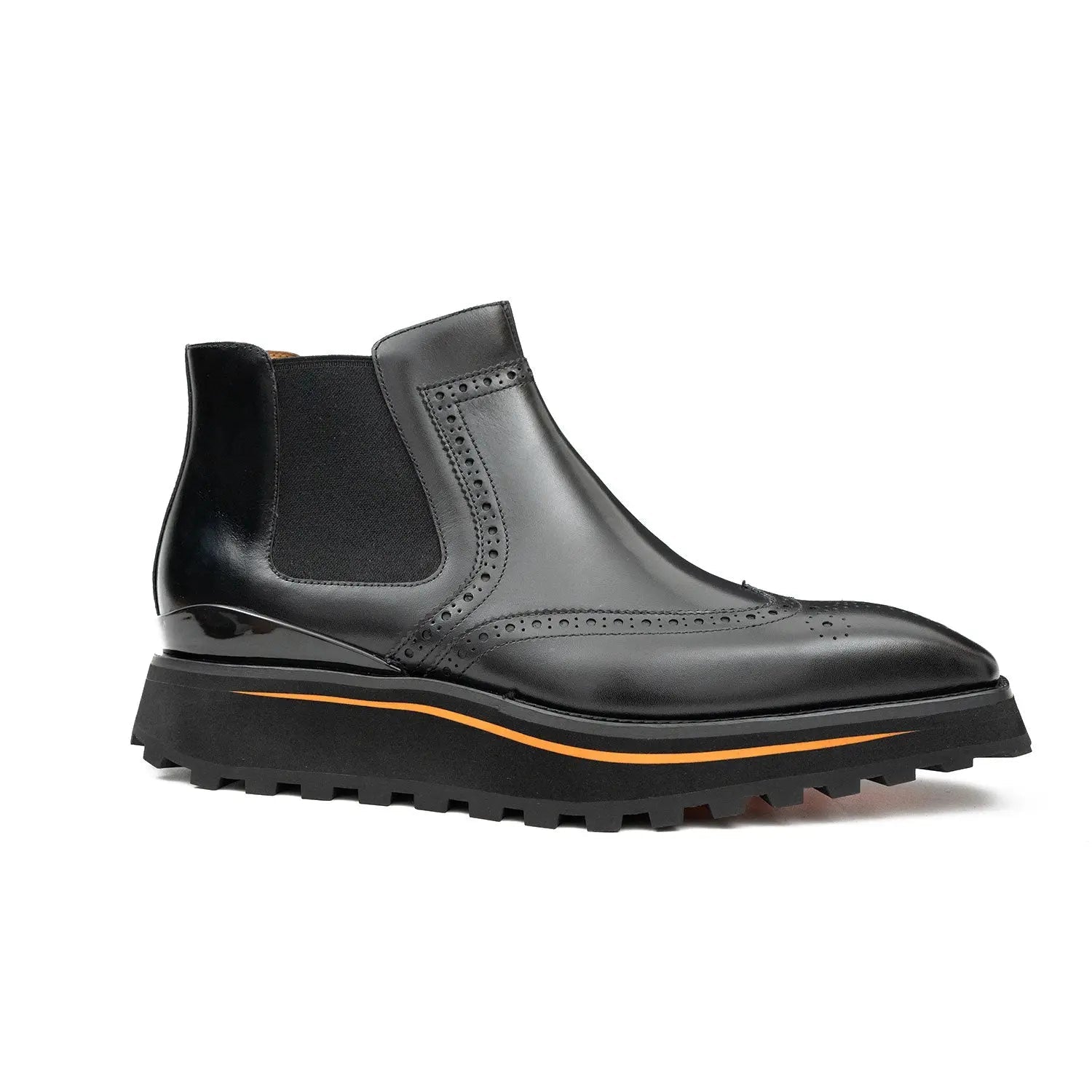 Black Chelsea boot with orange sole on a white background