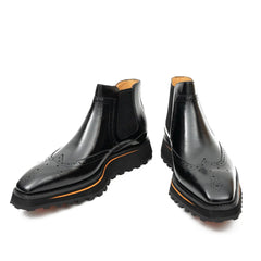 Pair of black leather Chelsea boots on a white background