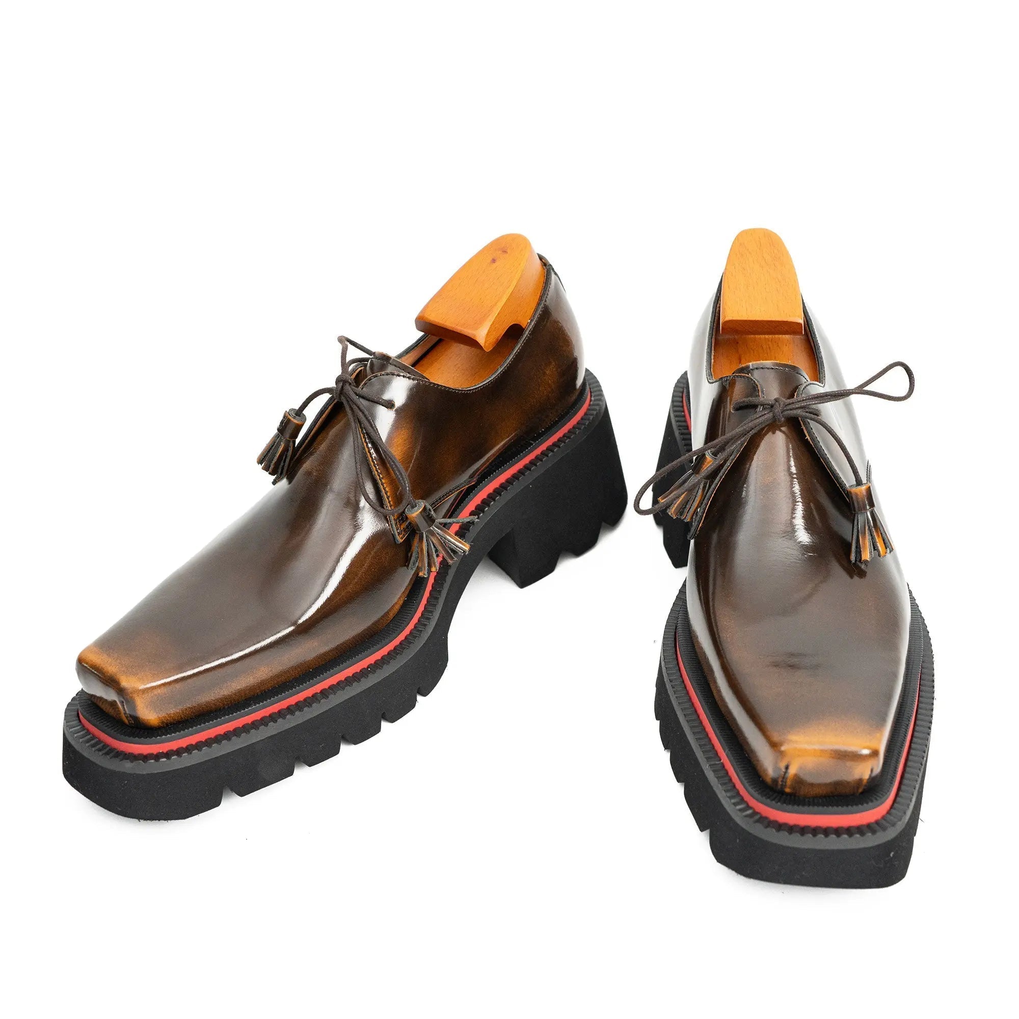 Pair of brown platform shoes with black soles on a white background