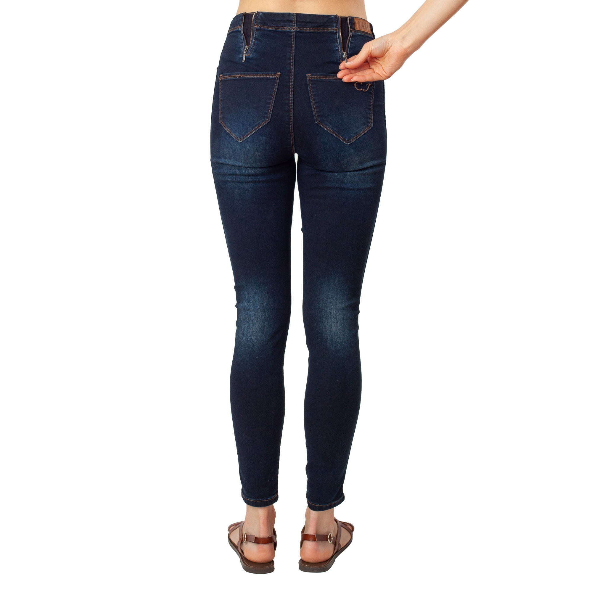 Dark blue jeans worn by a person on a white background