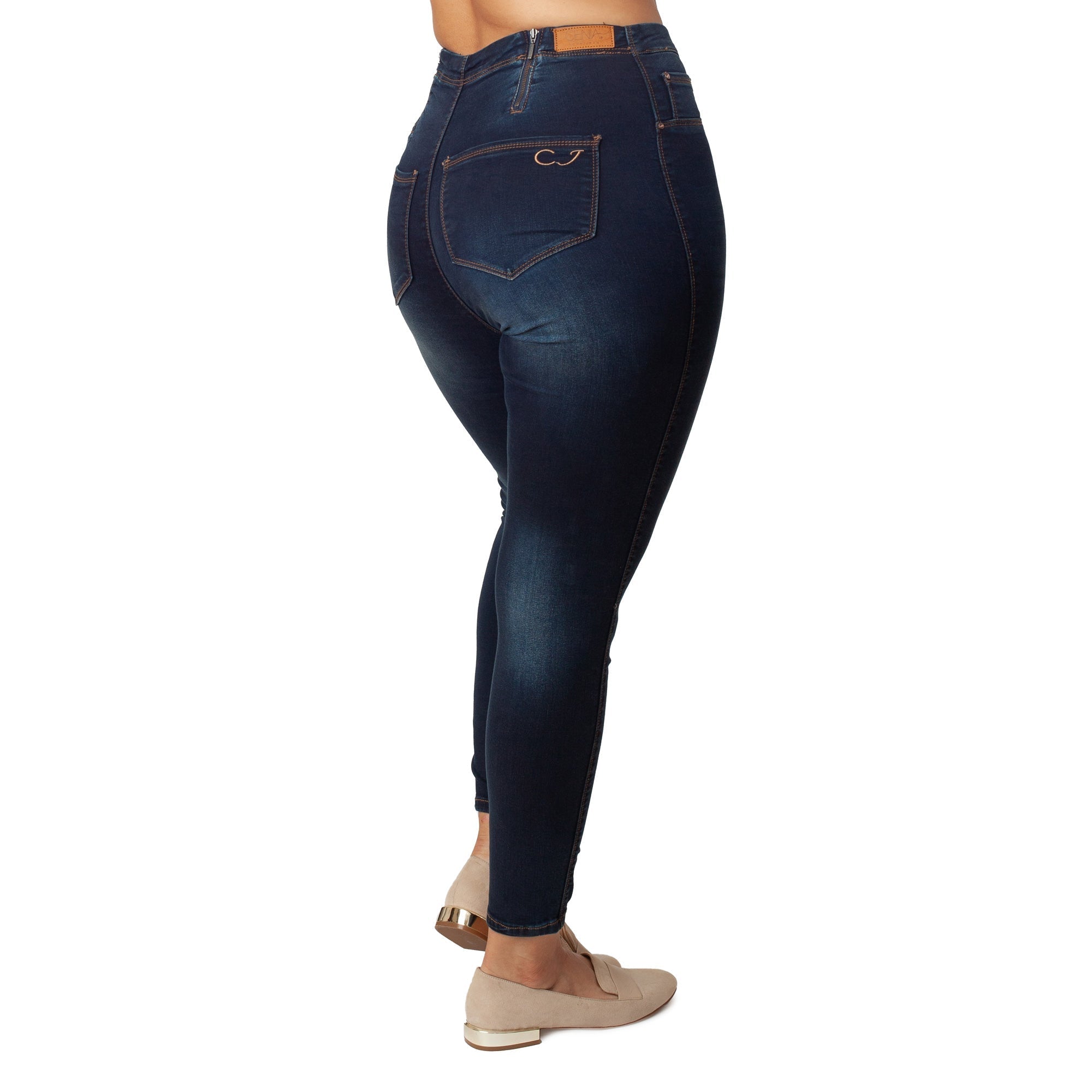 Dark blue jeans worn by a person on a white background