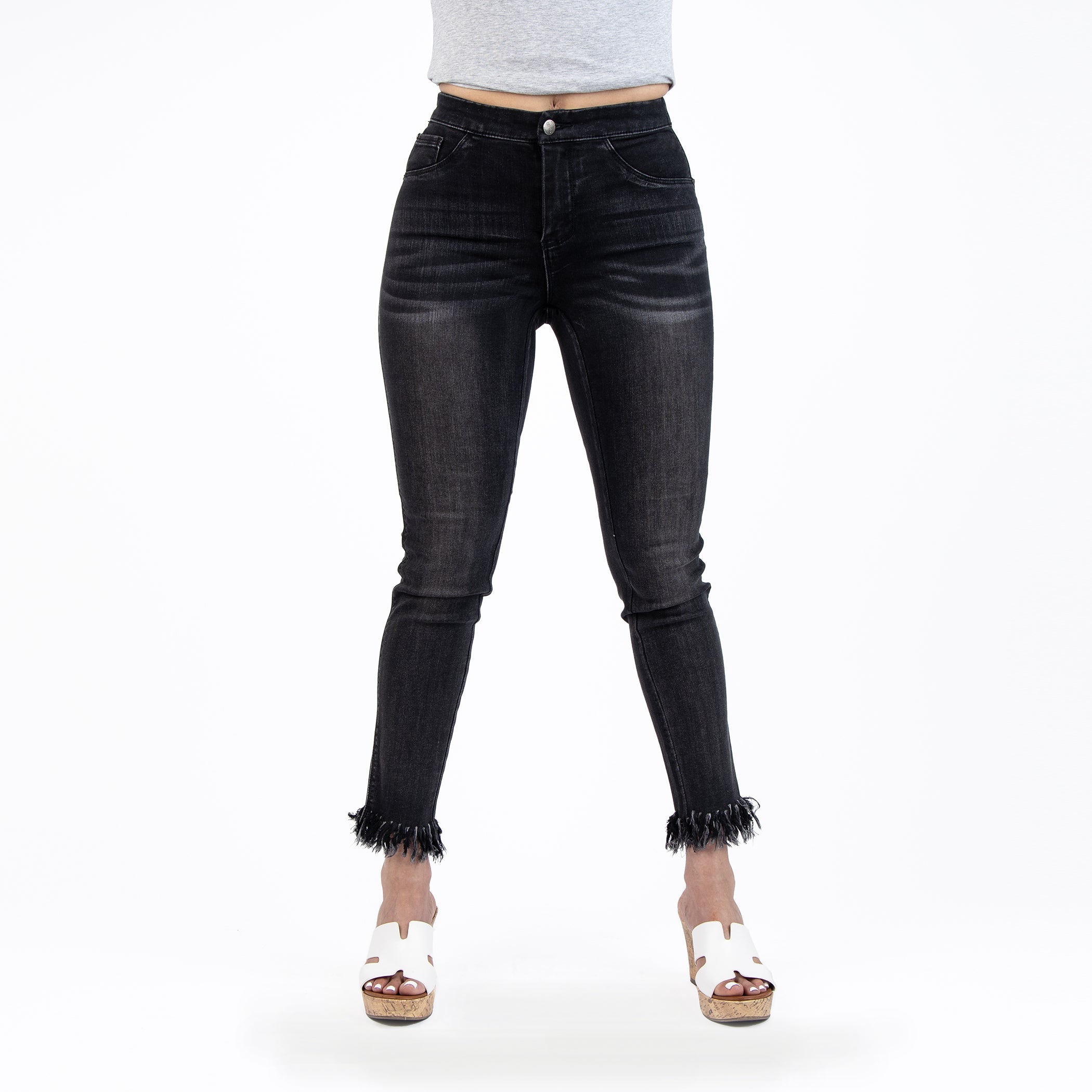 Black jeans worn by a person on a white background