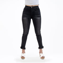Black jeans worn by a person on a white background