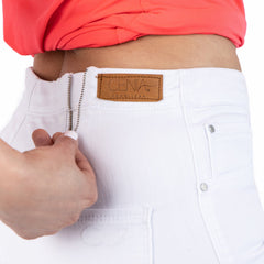 Close-up of white pants with a visible brand label on a white background