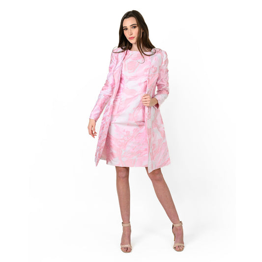 Woman wearing a pink floral dress on a white background