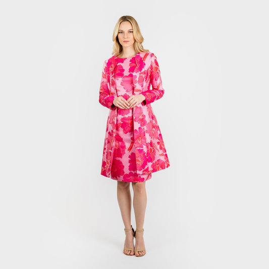 Woman wearing a pink floral dress on a white background