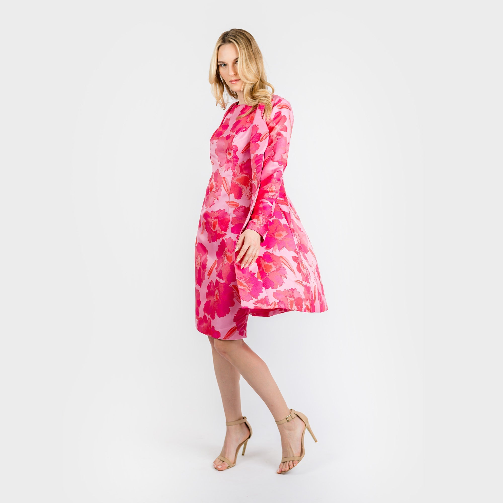 Woman wearing a pink floral dress on a white background