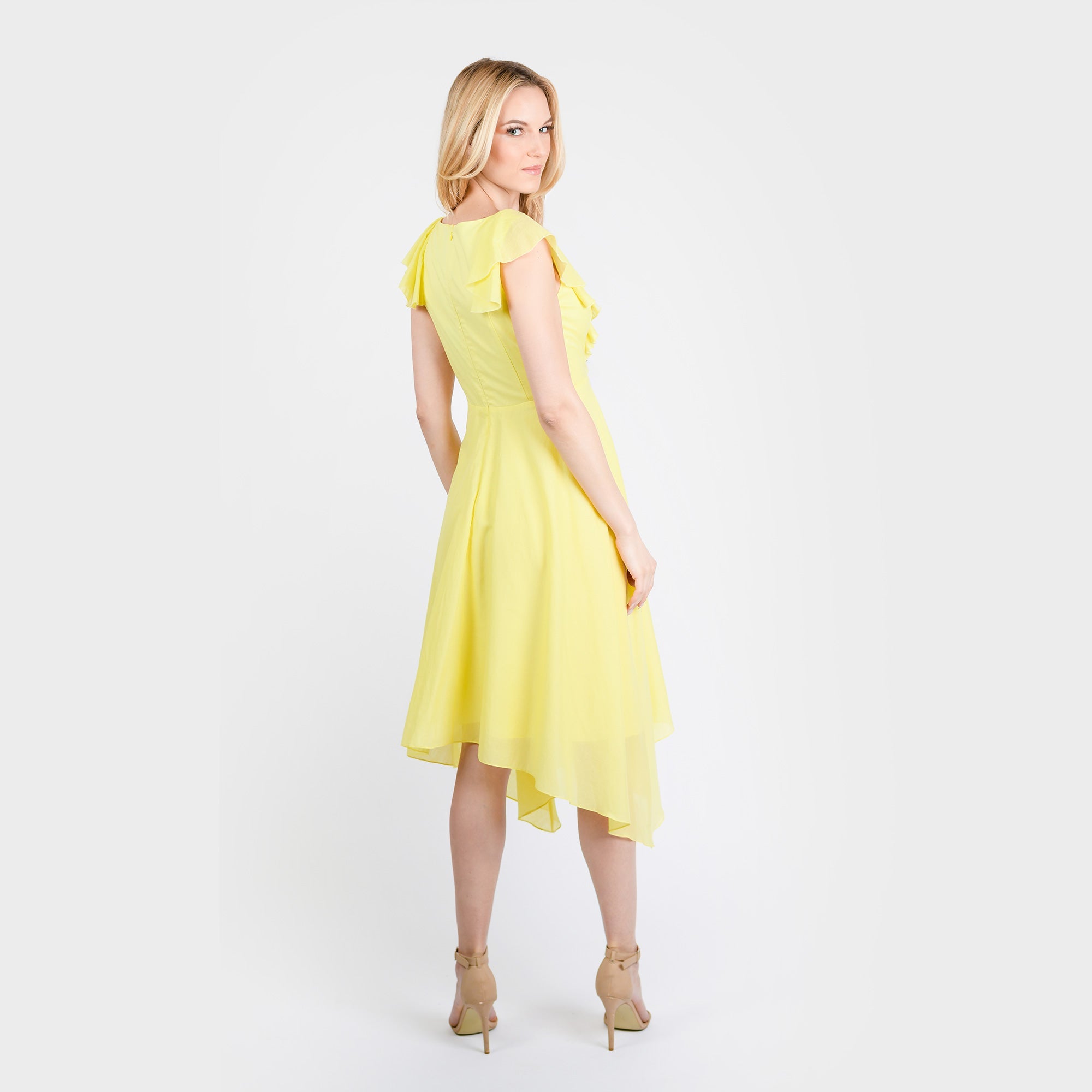 Woman wearing a yellow dress on a white background