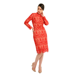 Woman wearing a red patterned dress on a white background