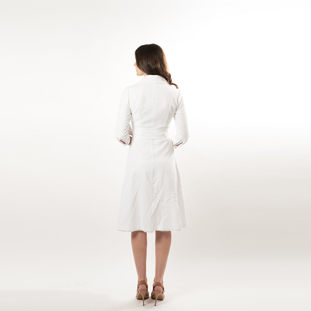 Woman wearing a white dress on a plain white background