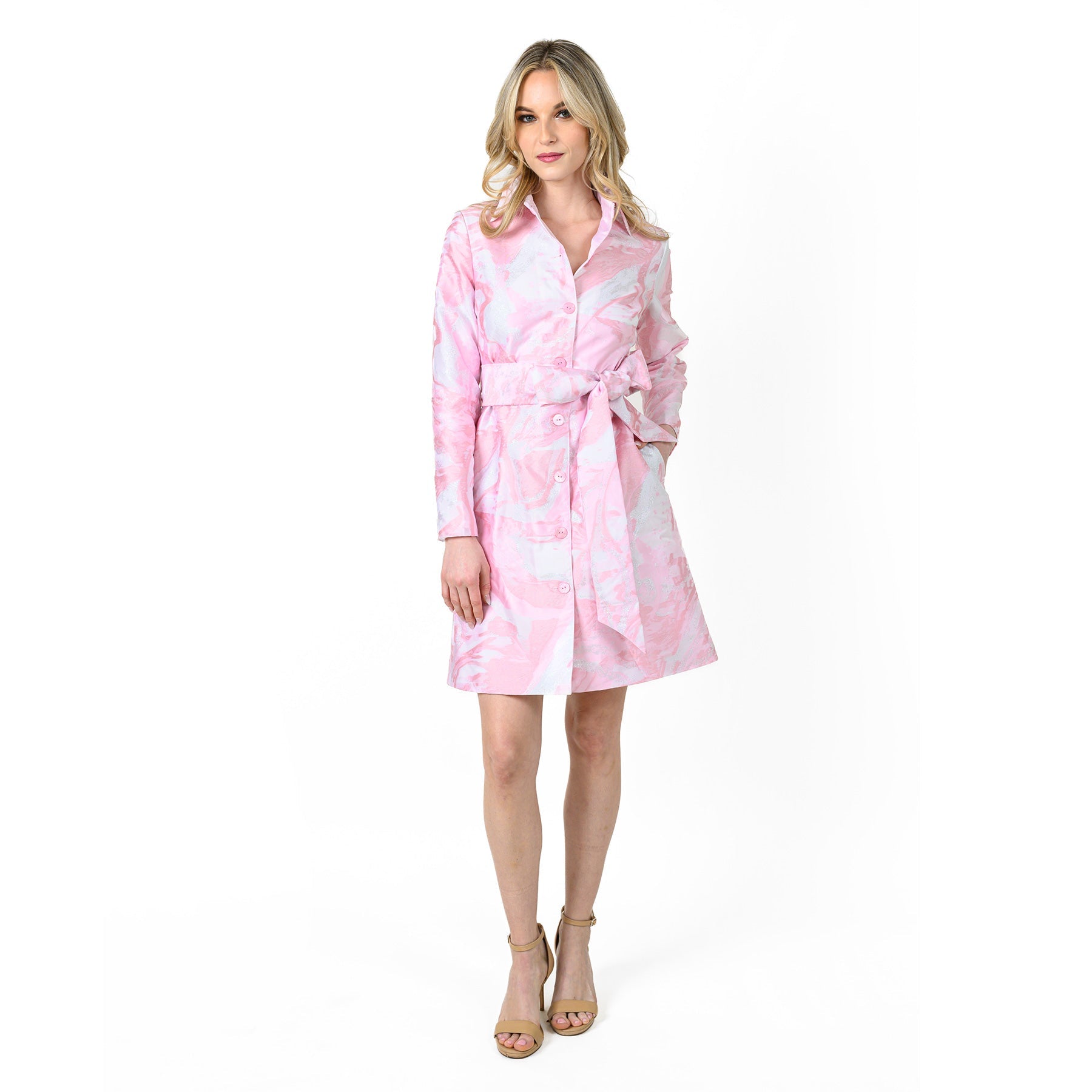 Woman wearing a pink and white patterned robe on a white background