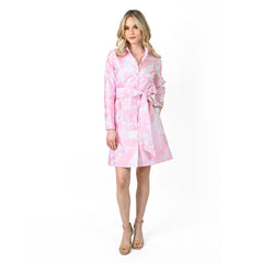Woman wearing a pink and white patterned robe on a white background