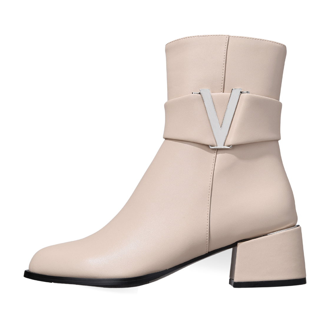 Beige ankle boot with a V-shaped design on a white background