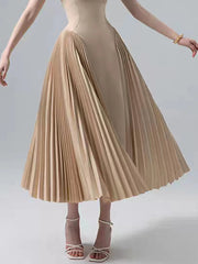 Beige pleated skirt worn by a person on a plain background